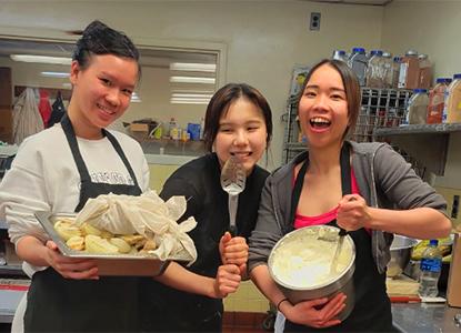 Hartwick College students in kitchen cooking